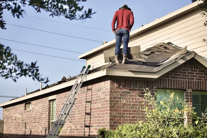 Professional roofer working on a residential roof in Clearville